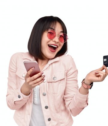 Cheerful ethnic lady using online banking service